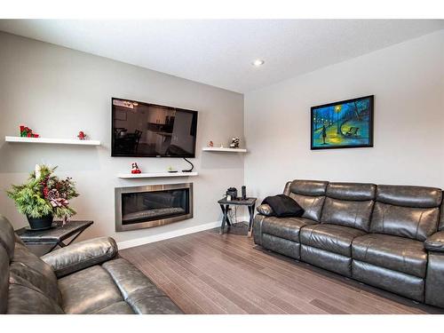 119 Cedar Square, Blackfalds, AB - Indoor Photo Showing Living Room With Fireplace