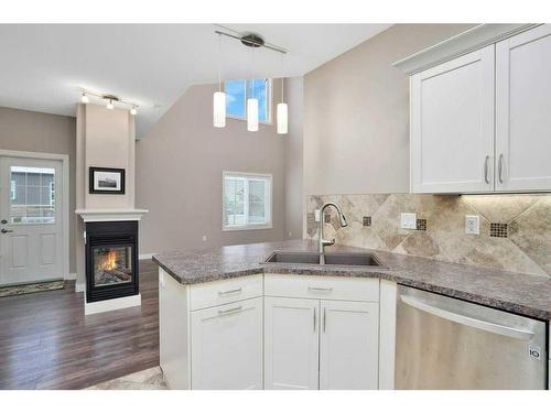 2 Garrison Place, Red Deer, AB - Indoor Photo Showing Kitchen With Fireplace With Double Sink