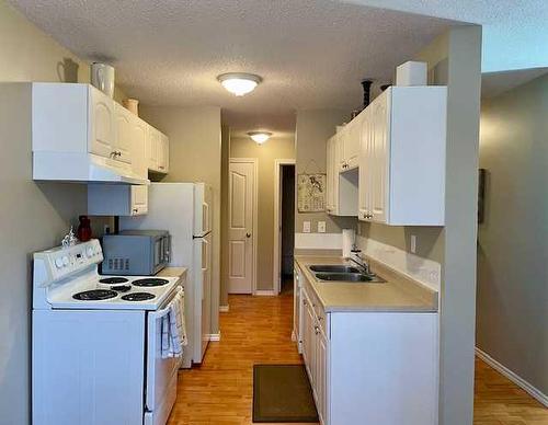 305-4904 54 Street, Red Deer, AB - Indoor Photo Showing Kitchen With Double Sink