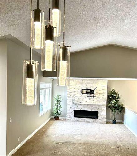 7 Canyon Court West, Lethbridge, AB - Indoor Photo Showing Other Room With Fireplace