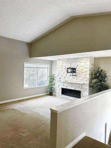 7 Canyon Court West, Lethbridge, AB - Indoor Photo Showing Other Room With Fireplace