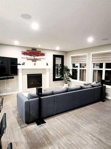 238 Kingfisher Crescent Se, Airdrie, AB - Indoor Photo Showing Living Room With Fireplace