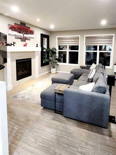 238 Kingfisher Crescent Se, Airdrie, AB - Indoor Photo Showing Living Room With Fireplace