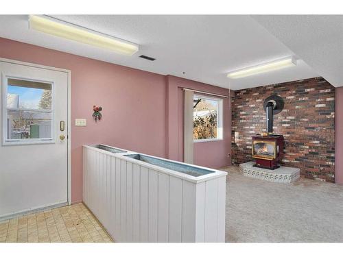 5836 58 Street, Rocky Mountain House, AB - Indoor Photo Showing Other Room With Fireplace