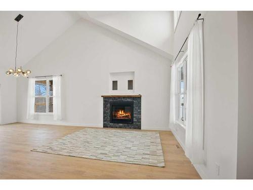 45 Bruhn Bend, Rural Ponoka County, AB - Indoor Photo Showing Living Room With Fireplace