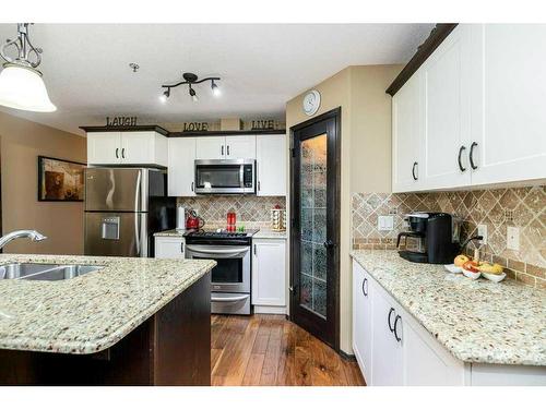 102-3515 49 Avenue, Red Deer, AB - Indoor Photo Showing Kitchen With Stainless Steel Kitchen With Double Sink With Upgraded Kitchen