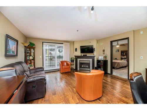 102-3515 49 Avenue, Red Deer, AB - Indoor Photo Showing Living Room With Fireplace