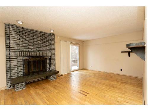 44 Hill Crescent, Red Deer, AB - Indoor Photo Showing Living Room With Fireplace