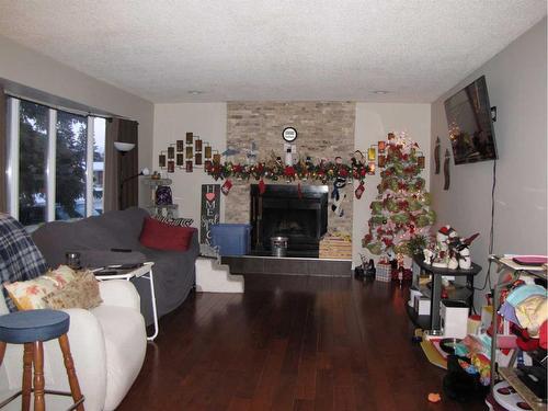 5223 37 Street, Innisfail, AB - Indoor Photo Showing Living Room With Fireplace