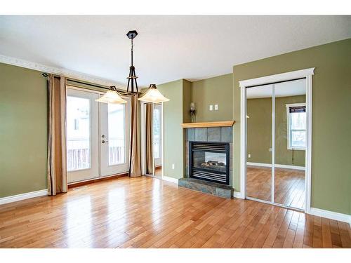 13-829 20 Street, Rural Red Deer County, AB - Indoor Photo Showing Living Room With Fireplace