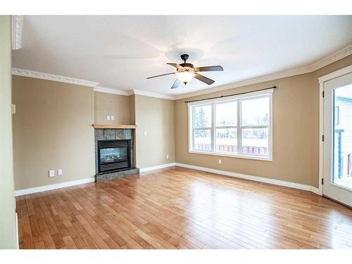 13-829 20 Street, Rural Red Deer County, AB - Indoor Photo Showing Living Room With Fireplace