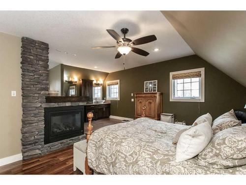 431 Summer Crescent, Rural Ponoka County, AB - Indoor Photo Showing Bedroom With Fireplace