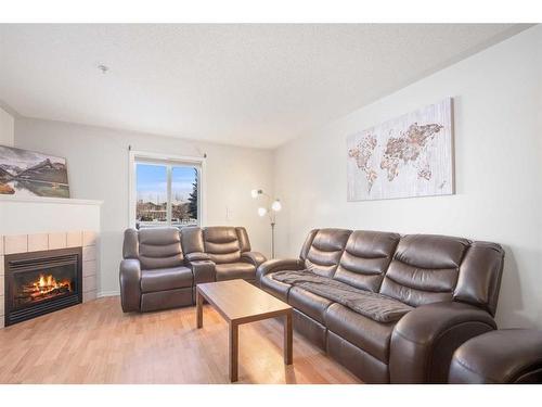 102-60 Lawford Avenue, Red Deer, AB - Indoor Photo Showing Living Room With Fireplace