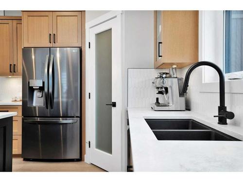 10 Songbird Green, Sylvan Lake, AB - Indoor Photo Showing Kitchen With Stainless Steel Kitchen With Double Sink