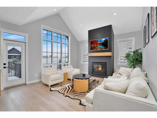 10 Songbird Green, Sylvan Lake, AB - Indoor Photo Showing Living Room With Fireplace