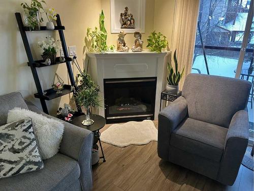 203-18 Averill Street, Red Deer, AB - Indoor Photo Showing Living Room With Fireplace