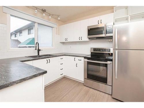 5007 58 Street, Lacombe, AB - Indoor Photo Showing Kitchen With Double Sink