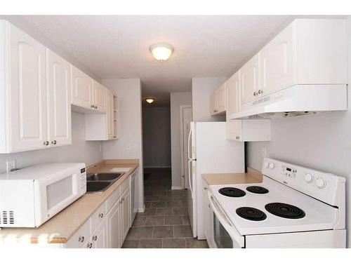 303-4904 54 Street, Red Deer, AB - Indoor Photo Showing Kitchen With Double Sink