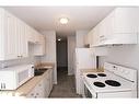 303-4904 54 Street, Red Deer, AB  - Indoor Photo Showing Kitchen With Double Sink 