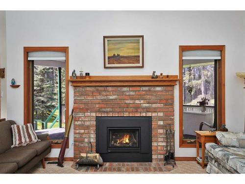 86-28319 Township Road 384, Rural Red Deer County, AB - Indoor Photo Showing Living Room With Fireplace