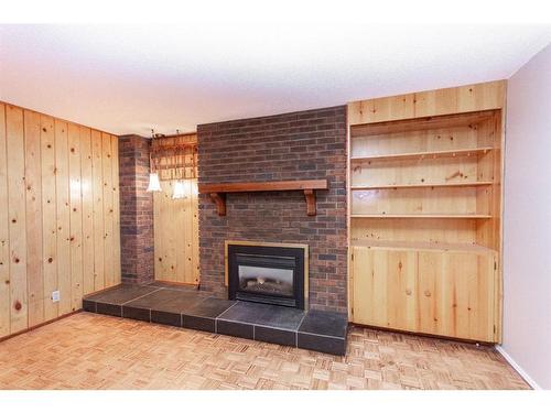 35 Barner Avenue, Red Deer, AB - Indoor Photo Showing Living Room With Fireplace