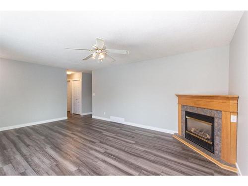 35 Barner Avenue, Red Deer, AB - Indoor Photo Showing Living Room With Fireplace