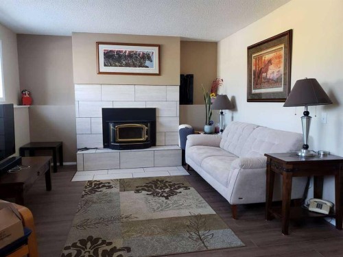471 Dalmeny Hill Nw, Calgary, AB - Indoor Photo Showing Living Room With Fireplace