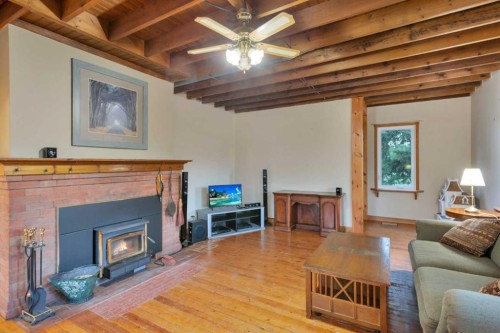 32328 Range Road 42, Rural Mountain View County, AB - Indoor Photo Showing Living Room With Fireplace