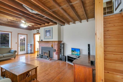 32328 Range Road 42, Rural Mountain View County, AB - Indoor Photo Showing Living Room With Fireplace