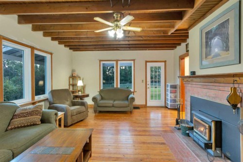 32328 Range Road 42, Rural Mountain View County, AB - Indoor Photo Showing Living Room With Fireplace