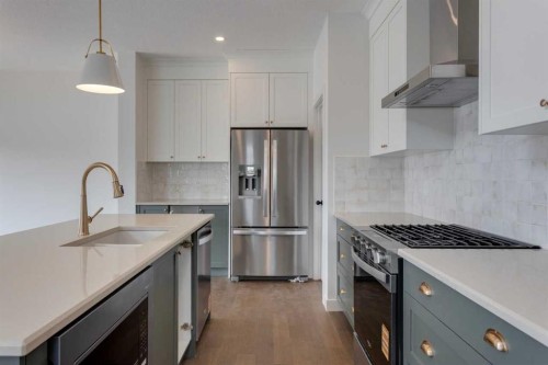 21 Bayview Mews Sw, Airdrie, AB - Indoor Photo Showing Kitchen With Stainless Steel Kitchen With Upgraded Kitchen