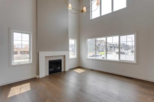 21 Bayview Mews Sw, Airdrie, AB - Indoor Photo Showing Living Room With Fireplace
