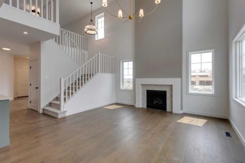 21 Bayview Mews Sw, Airdrie, AB - Indoor Photo Showing Other Room With Fireplace