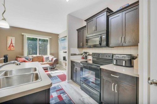 5-5301 Windward Place, Sylvan Lake, AB - Indoor Photo Showing Kitchen With Double Sink