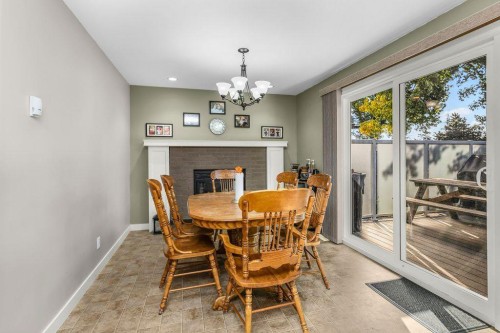 33 Fairway Drive, Lacombe, AB - Indoor Photo Showing Dining Room With Fireplace