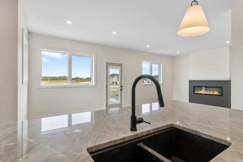 10 Aura Drive, Blackfalds, AB - Indoor Photo Showing Kitchen With Fireplace With Double Sink