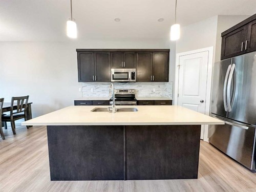 4438 Van Eaton Way, Clive, AB - Indoor Photo Showing Kitchen With Stainless Steel Kitchen With Double Sink With Upgraded Kitchen