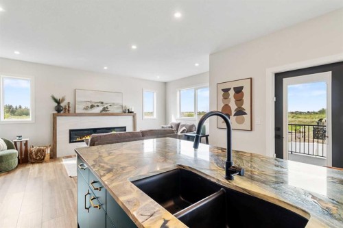 22 Aura Drive, Blackfalds, AB - Indoor Photo Showing Kitchen With Fireplace