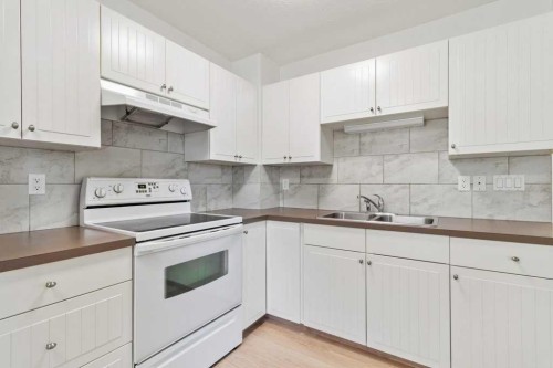 5016 44 Street, Sylvan Lake, AB - Indoor Photo Showing Kitchen With Double Sink