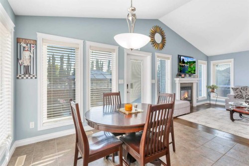 5 Heritage Drive, Penhold, AB - Indoor Photo Showing Dining Room With Fireplace