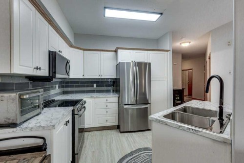 304-5300 48 Street, Red Deer, AB - Indoor Photo Showing Kitchen With Double Sink With Upgraded Kitchen