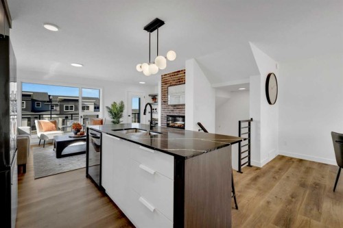 26 Violet Point, Sylvan Lake, AB - Indoor Photo Showing Kitchen With Fireplace