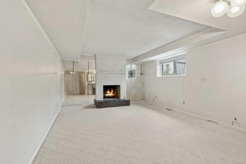 59 Nyman Crescent, Red Deer, AB - Indoor Photo Showing Other Room With Fireplace
