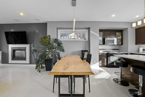 709 Cypress Lane, Springbrook, AB - Indoor Photo Showing Dining Room With Fireplace