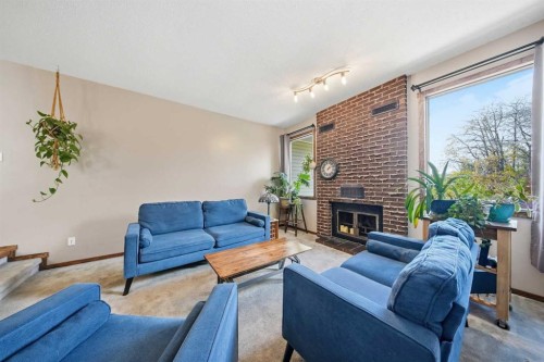 55 Nyman Crescent, Red Deer, AB - Indoor Photo Showing Living Room With Fireplace