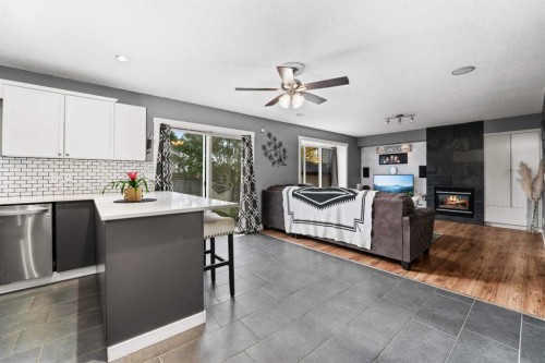 2034 Luxstone Boulevard Sw, Airdrie, AB - Indoor Photo Showing Kitchen With Fireplace