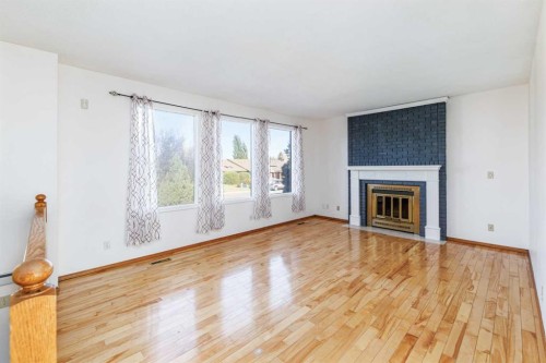 32 Huget Crescent, Red Deer, AB - Indoor Photo Showing Living Room With Fireplace