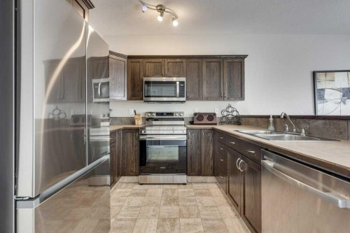111-50 Lucky Place, Sylvan Lake, AB - Indoor Photo Showing Kitchen With Stainless Steel Kitchen With Double Sink