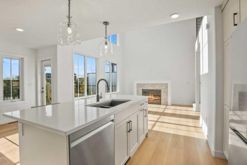 5 Songbird Green, Sylvan Lake, AB - Indoor Photo Showing Kitchen With Fireplace With Double Sink With Upgraded Kitchen