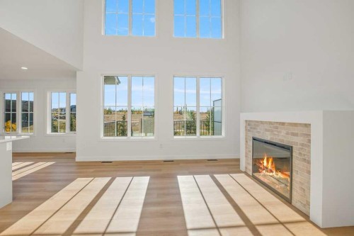 5 Songbird Green, Sylvan Lake, AB - Indoor Photo Showing Living Room With Fireplace